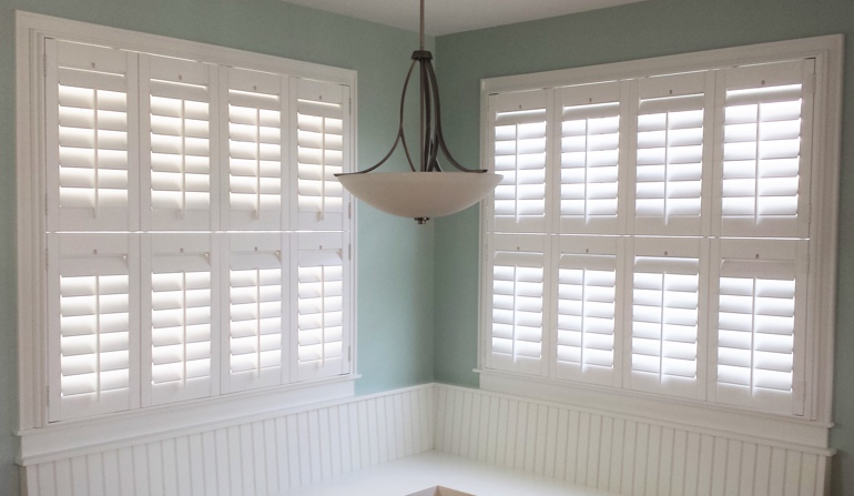 Pastel green wall in Honolulu kitchen with shutters.